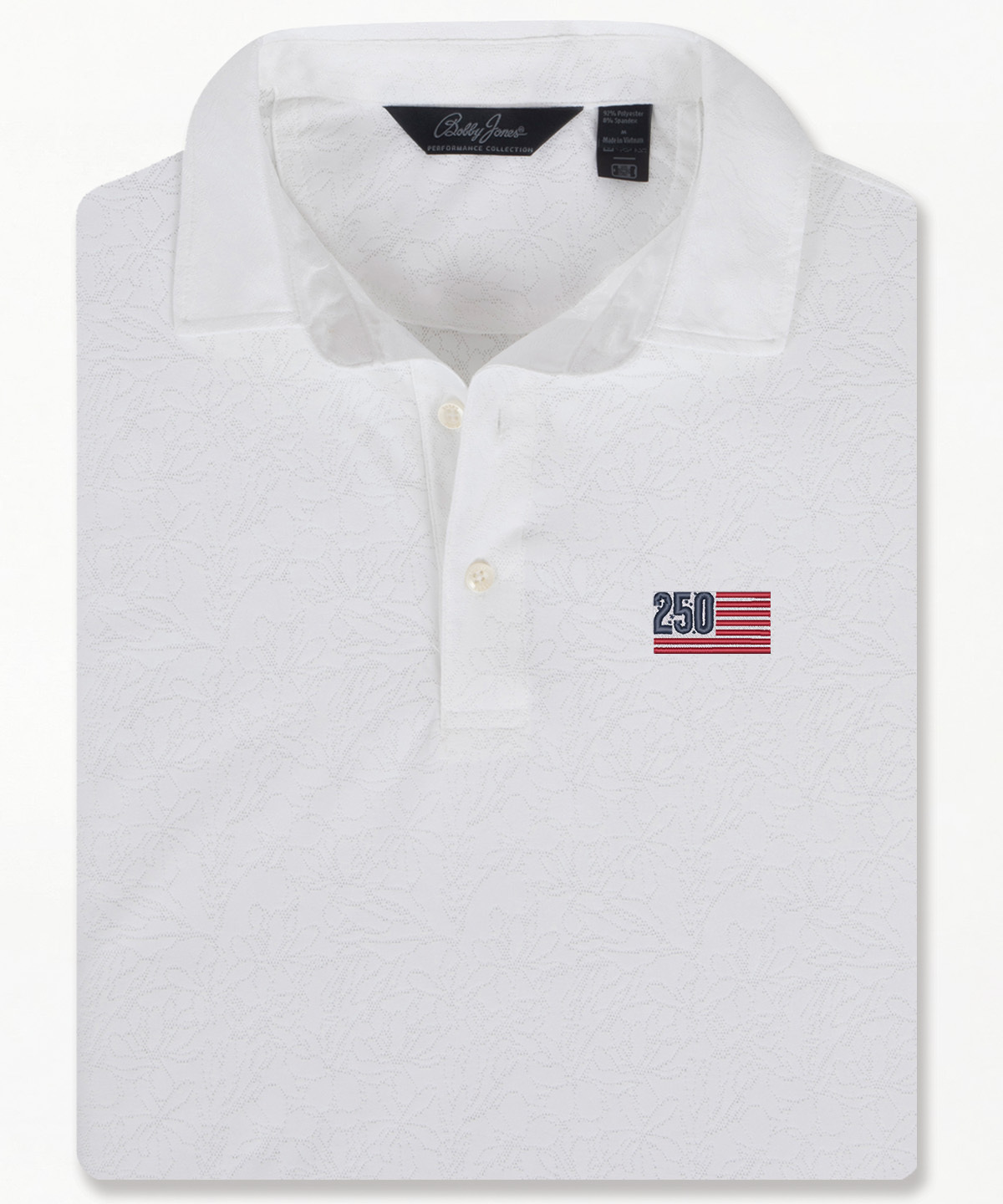 Bobby Jones men’s white jacquard golf polo with subtle floral pattern, short sleeves, and three-button placket, folded to highlight textured design and tailored collar.