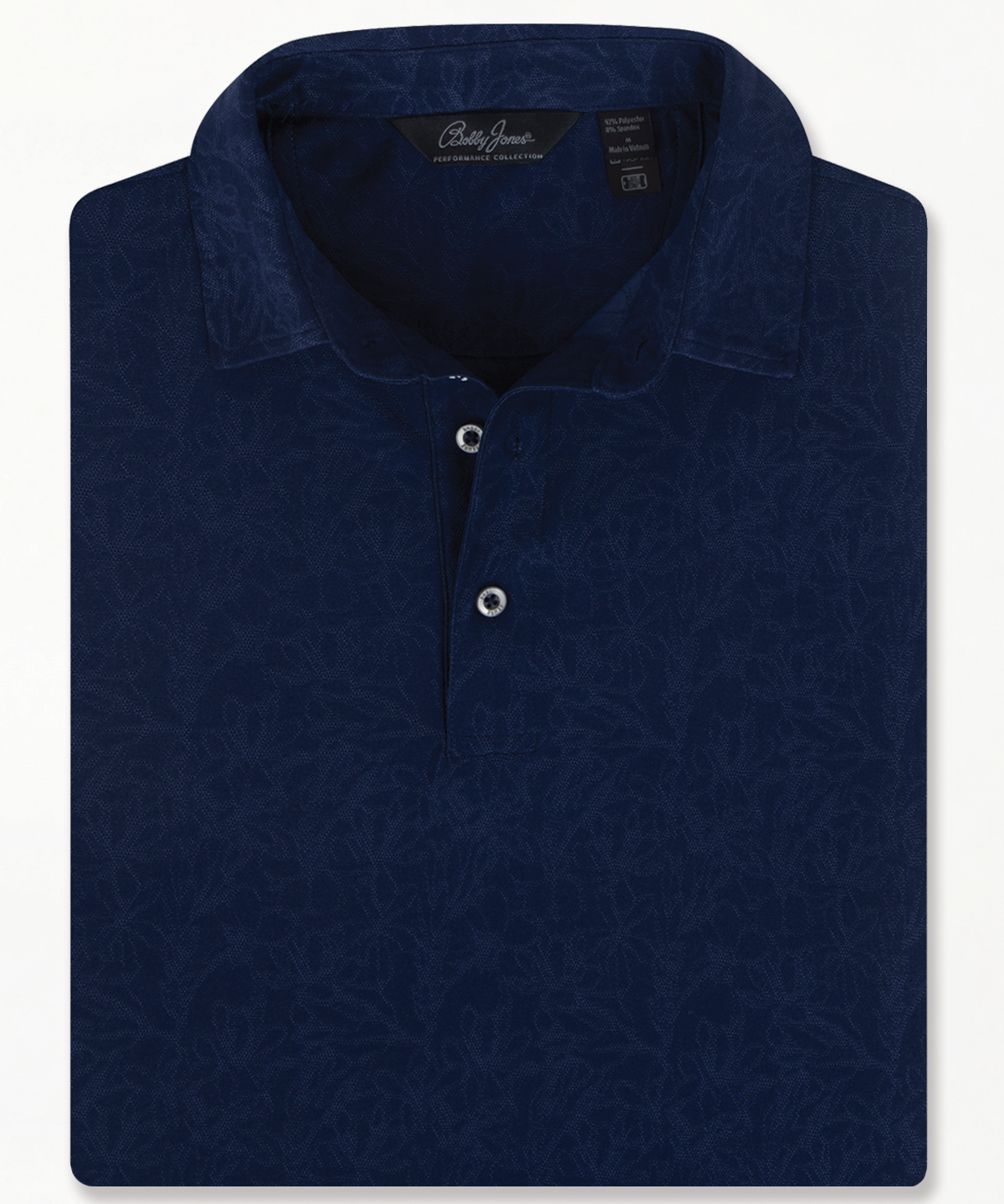 Bobby Jones men’s navy jacquard golf polo with subtle floral pattern, short sleeves, and three-button placket, folded to highlight textured design and tailored collar.